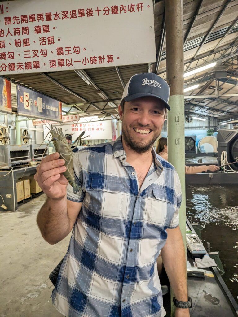 Robby holding a shrimp. He caught shrimp fishing. 